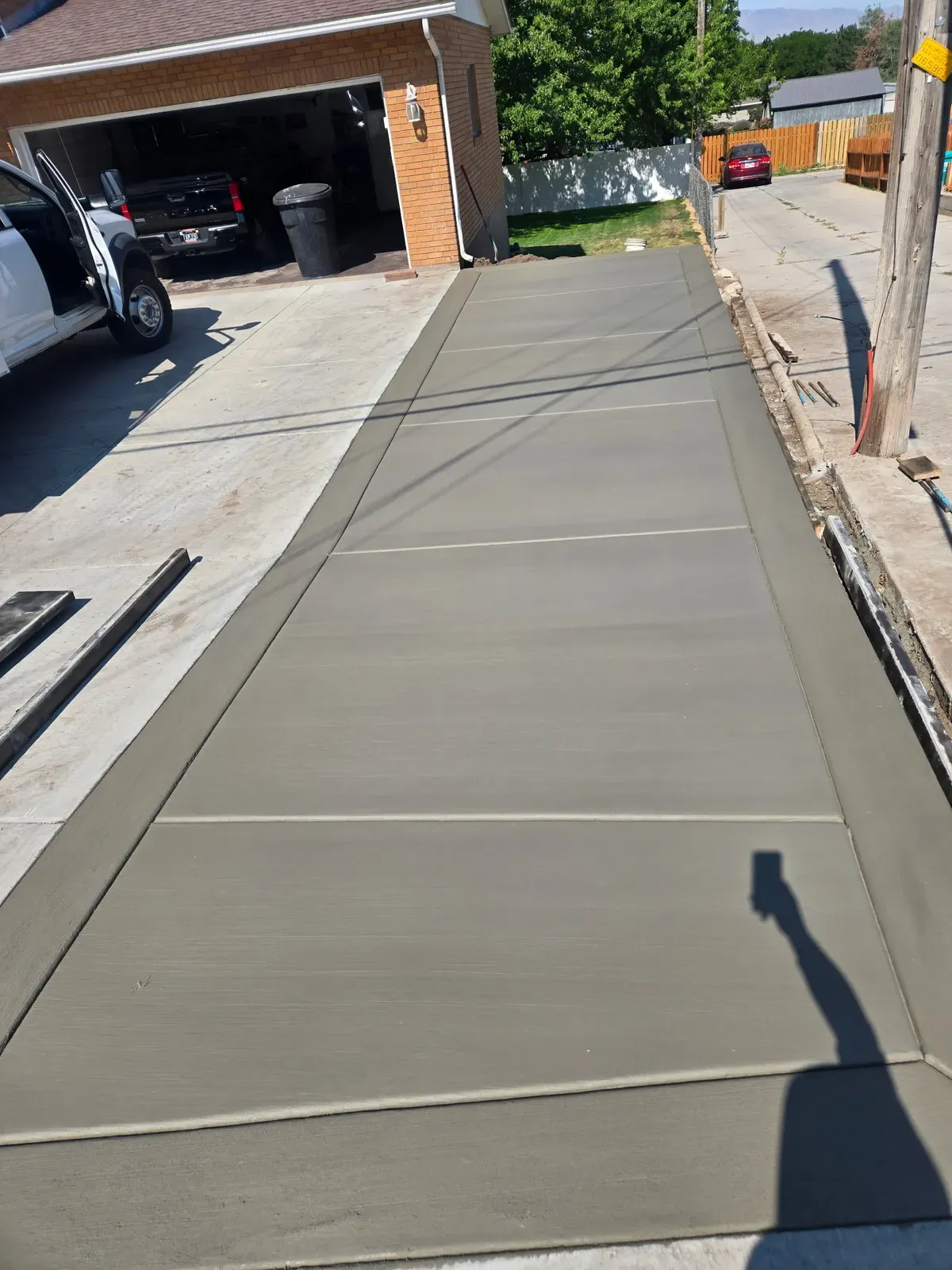 Picture-frame broom-finish concrete walkway beside a Centerville garage
