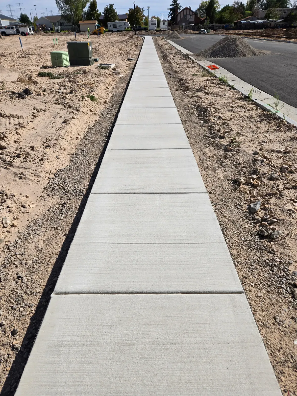 New sidewalk and street curb with broom finish in a Clinton subdivision